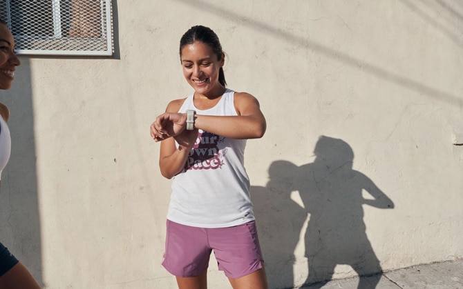 Une femme qui regarde sa montre avant son run